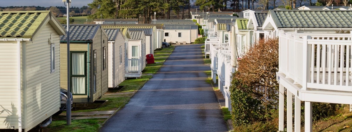 path running through two rows of static caravans on a static caravan park